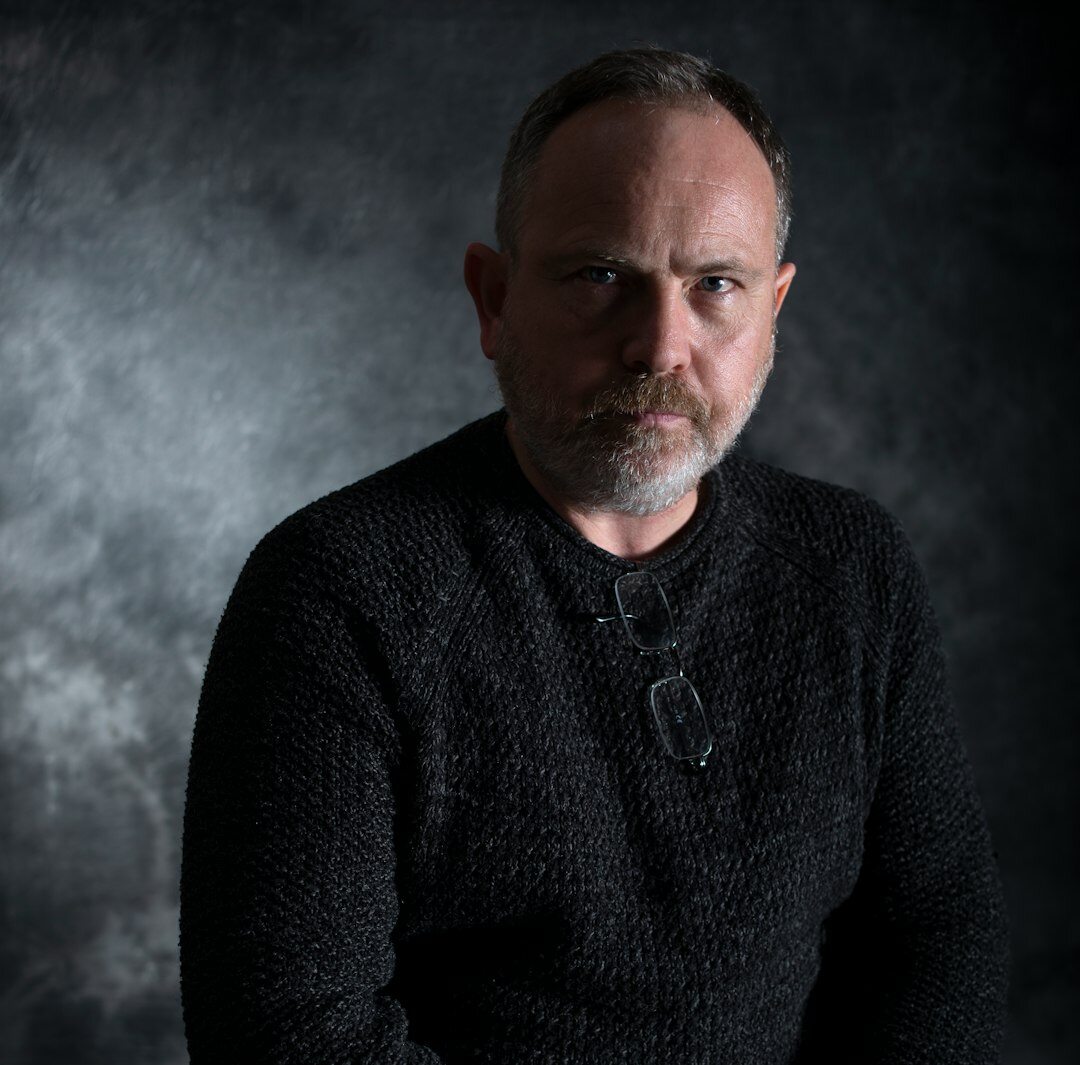Studio portrait of a man with a beard in business casual attire
