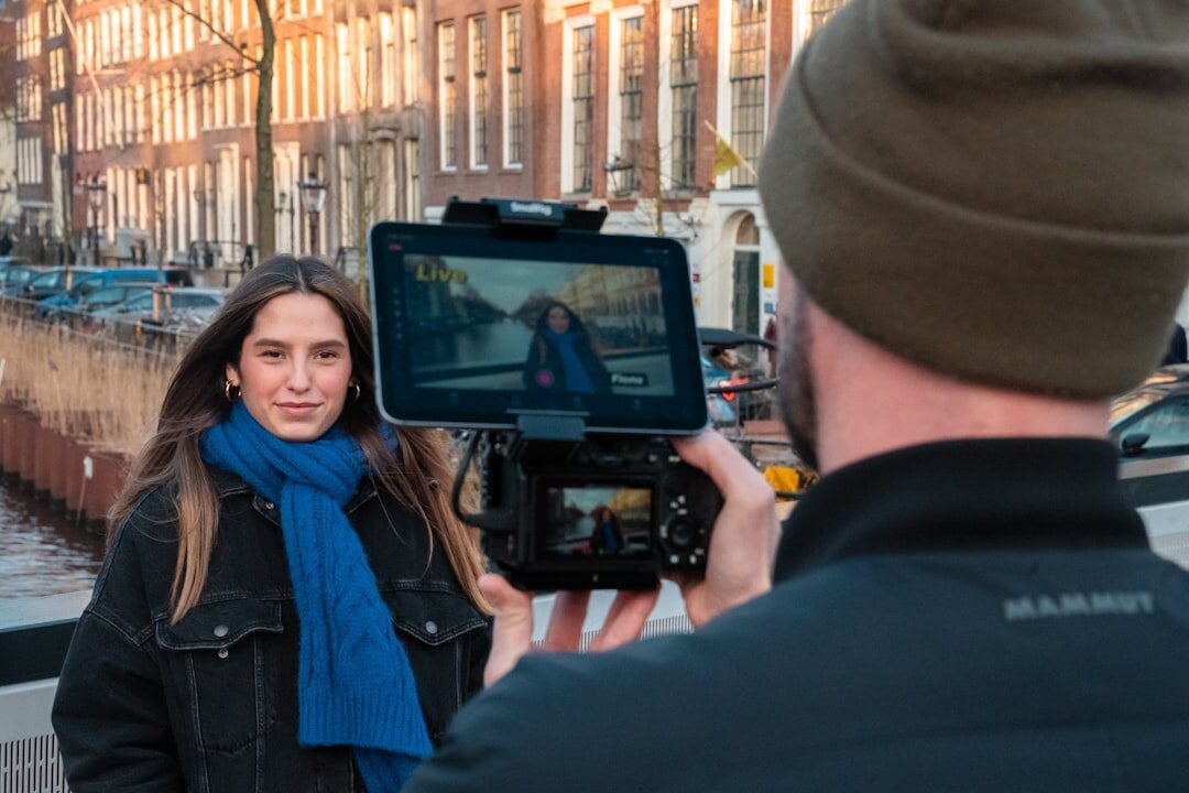Camera operator setting up a professional video camera on location