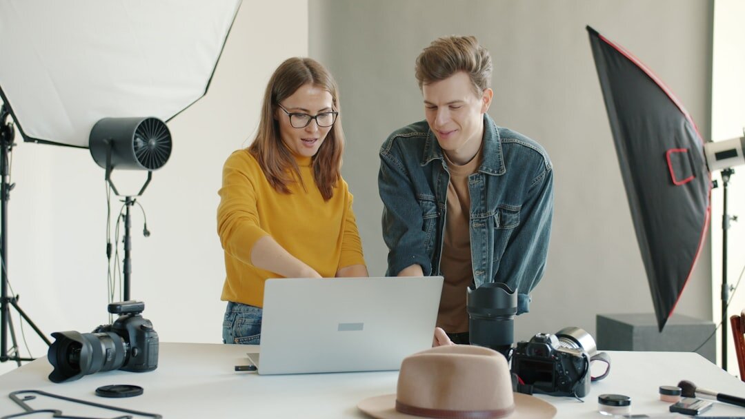 Two colleagues reviewing footage together on a laptop